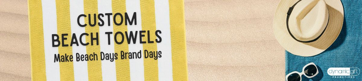 A custom logo beach towel laying on Canada's sandy Wasaga beach beside summer event swag.