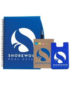 A blue journal with a white logo next to a natural coloured sticky note set with a blue logo and a blue silicone cellphone sleeve with a white logo next to that