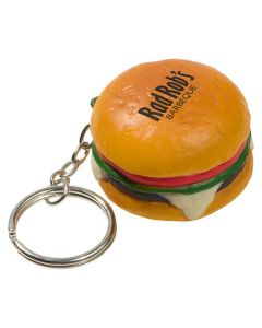 A hamburger shaped keychain stress reliever with a black logo on the top and a metal keychain and split ring attached
