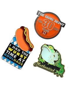three different shaped lapel pins with different coloured soft enamel