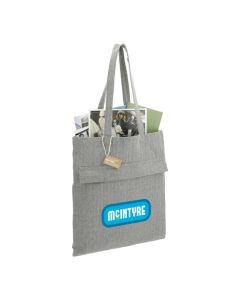 A branded recycled cotton tote filled with paperwork. The custom print on the front is blue, green and white.