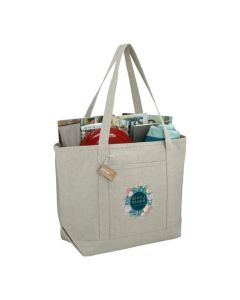 A custom logo boat tote made from recycled cotton. It is filled with beach accessories and the front has a full colour print.