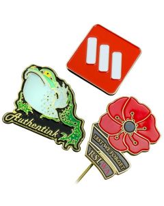 three different shaped lapel pins with different coloured soft enamel