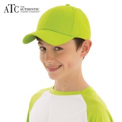 A child wearing a lime green and white baseball t-shirt, white pants and a lime green twill youth cap