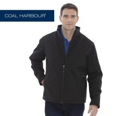 A black insulated soft shell jacket with a full zip being worn by a man with short hair and one hand in his pocket