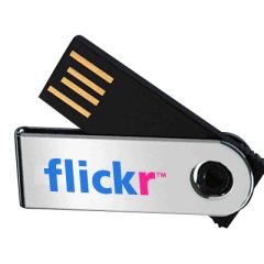 A custom logo mini USB swivel with a chip. The body is black and swivel is silver, it's printed with a blue and pink logo.