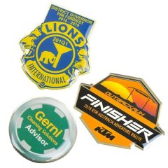 three different coloured full colour epoxy domed lapel pins two custom shaped and one round