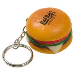 A hamburger shaped keychain stress reliever with a black logo on the top and a metal keychain and split ring attached