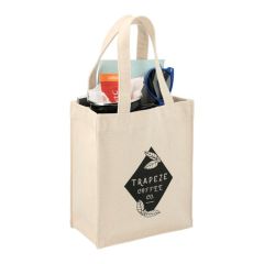 A custom printed mini cotton gift tote filled with swag. The front has a black logo on it.