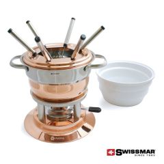 A copper coloured and white ceramic 11pc fondue set with 6 fondue forks resting inside and a white ceramic bowl beside it