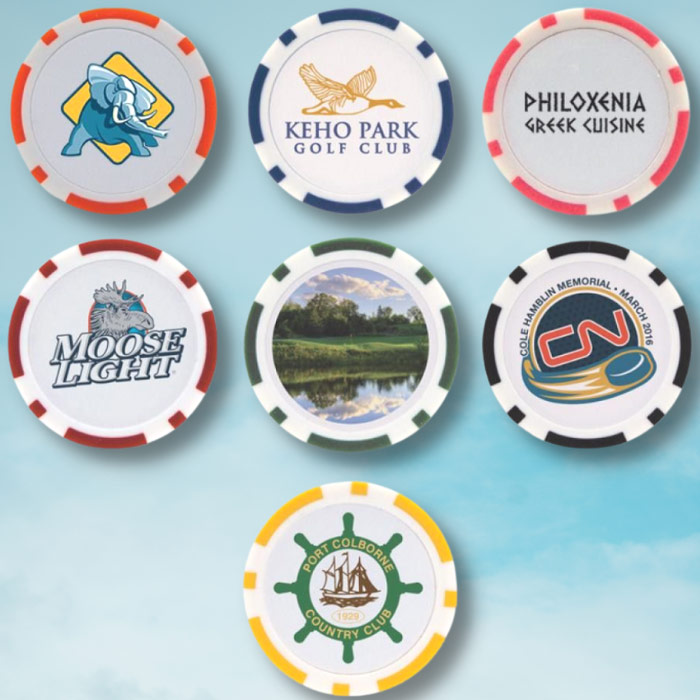 7 poker chips in different colours, featuring different company logos on each. All 7 chips are laid over a bright blue sky background overlooking a golf course.