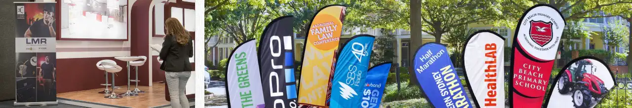 A retractable banner at indoor convention, beside custom feather flags and printed teardrop flags used for events in Ontario.