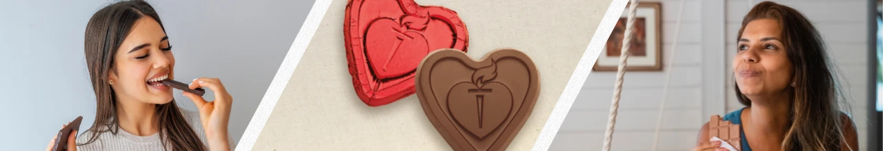 Two people enjoying deluxe custom branded chocolate in Canada with two heart-shaped chocolate candies in the centre of the image.